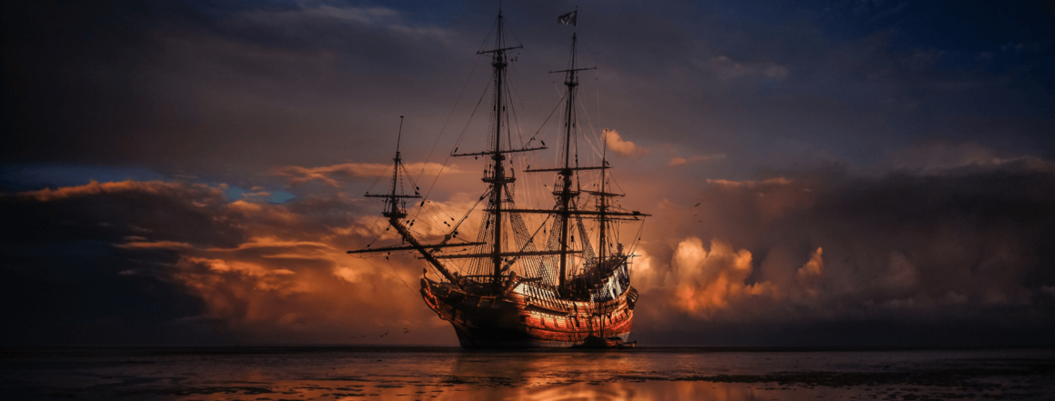 Altes Piratenschiff bei Sonnenuntergang auf dem Meer