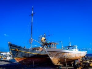 2 large boats in a harbour, boat maintenance