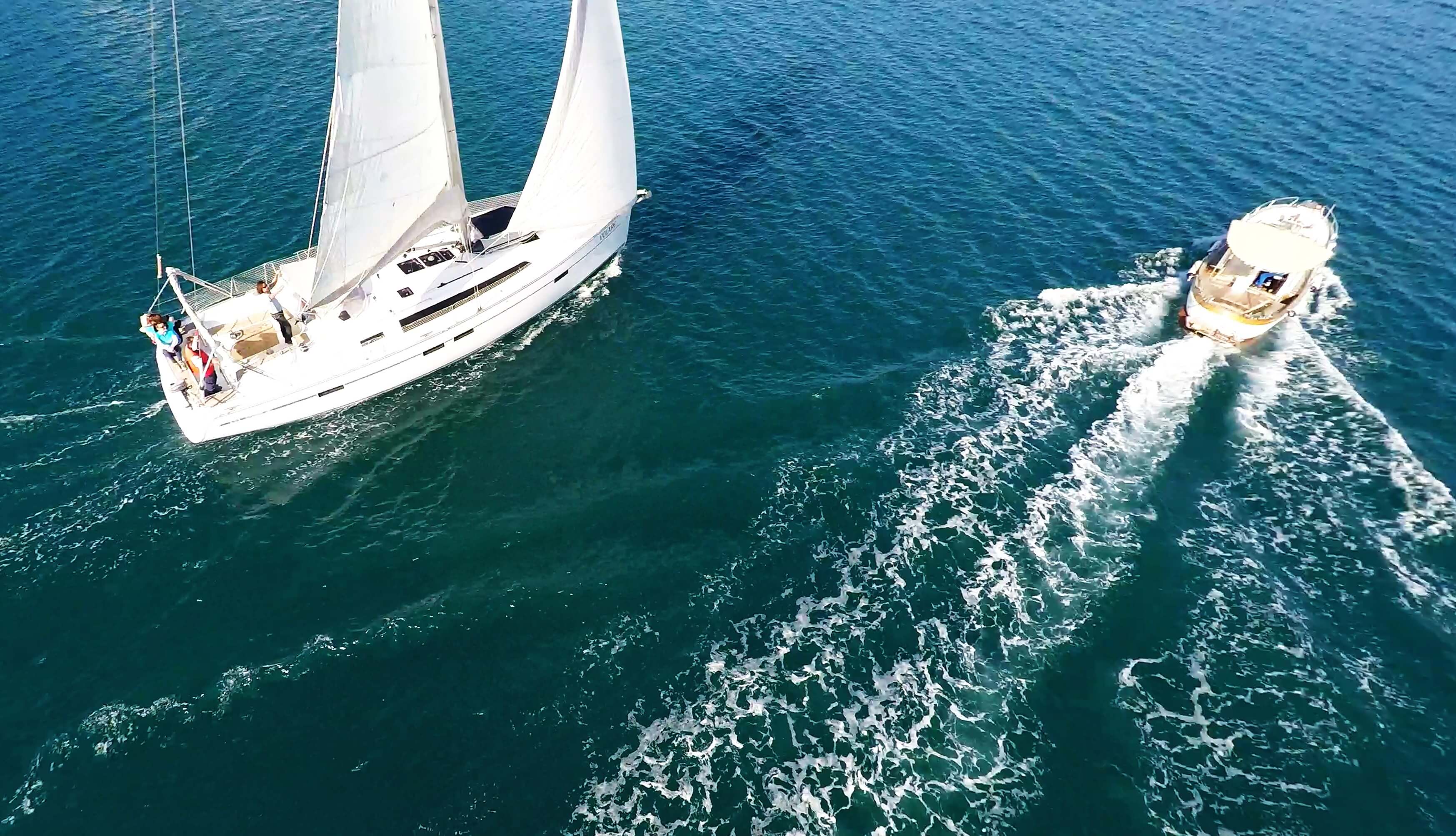 motorboat overtaken by sailboat