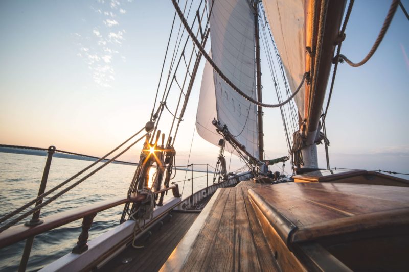 View of a sailboat sailing during sunset