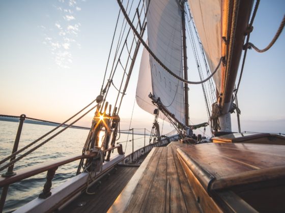 Sailing into the sunset on board a sailboat with ropes and knots