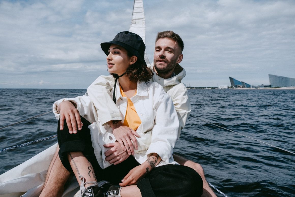 A couple sitting together on a boat and smiling