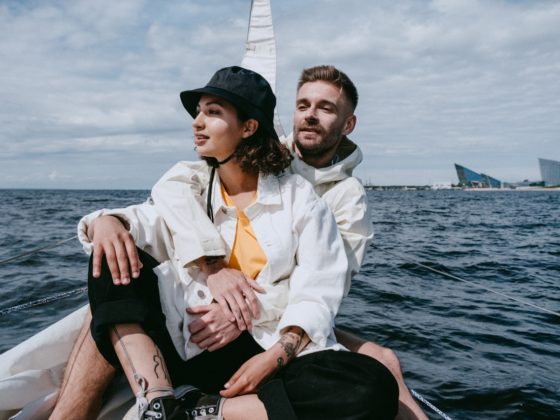 A couple sitting together on a boat and smiling