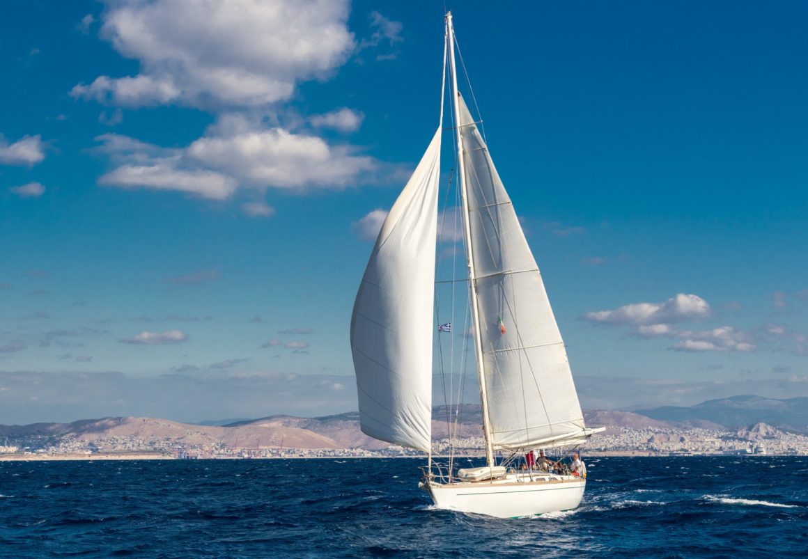 A white sailboat on the water in Greece.