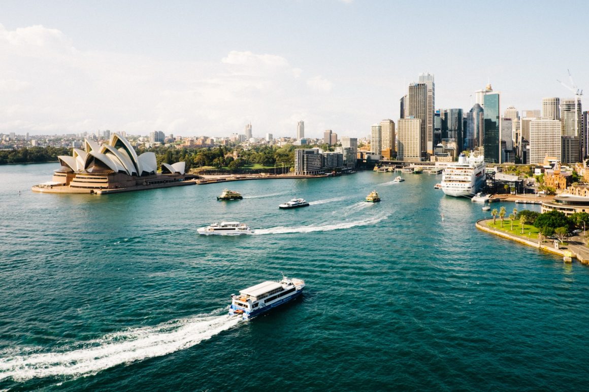 View of Sydney harbour, boats in the foreground and the city skyline in the background. 