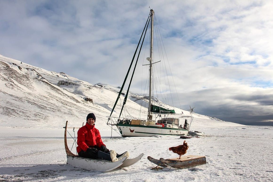 Guirec and his hen Monique on the Greenland ice sheet, his boat is behind.