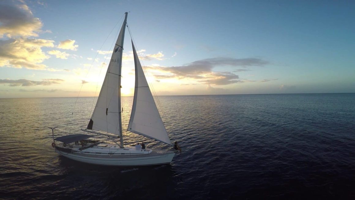 Sailboat out in the open seas during sunset