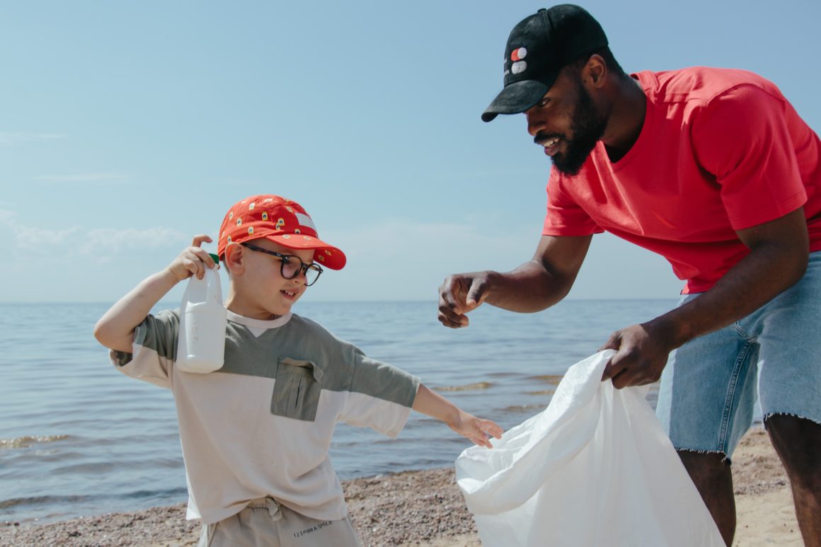 Two volunteers picking up litter on beach