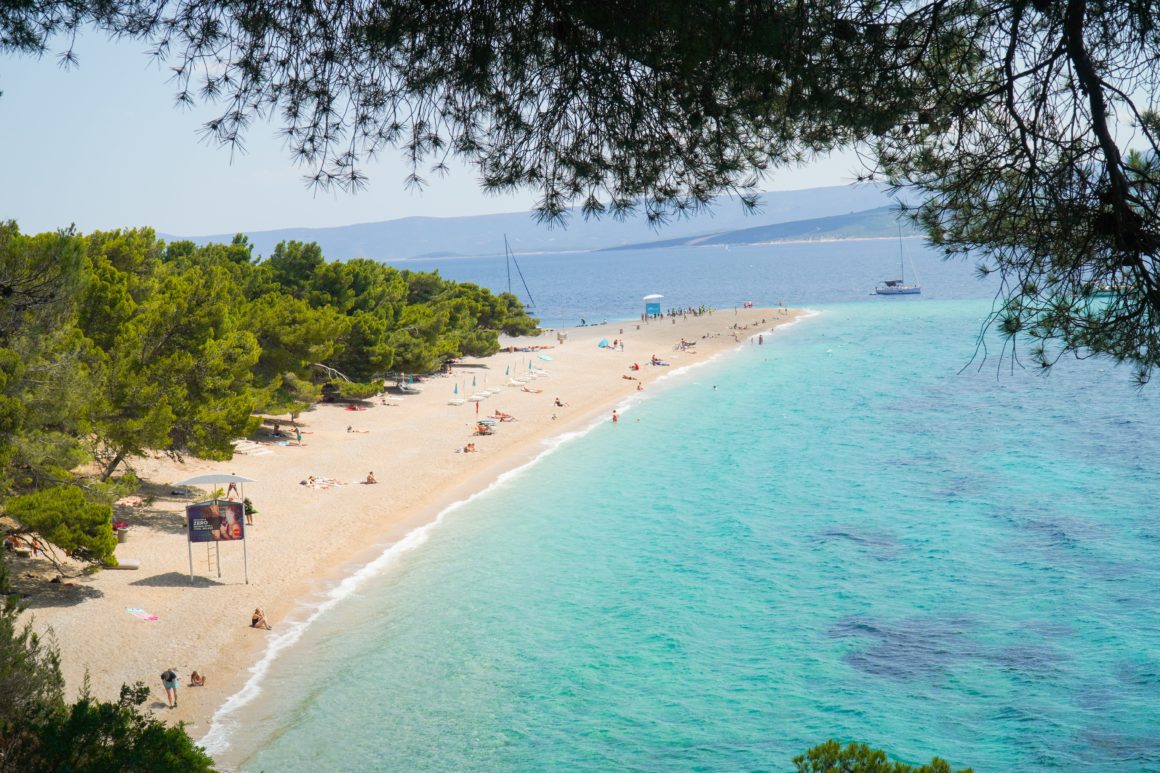 Long sandy beach, turquoise water, forests