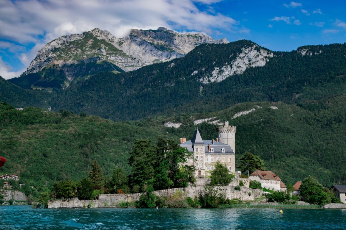 Photo of Lake Annecy. One of the best lakes in Europe. A lake in the foreground and a castle-like chateau in background, surrounded by mountains.
Best Lakes in Europe