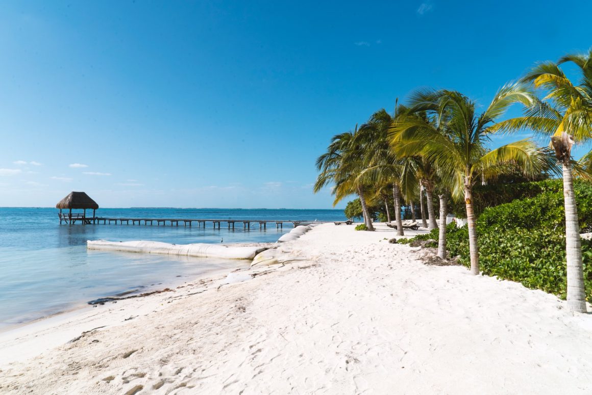 A Mexican beach with soft white sands and calm waters.