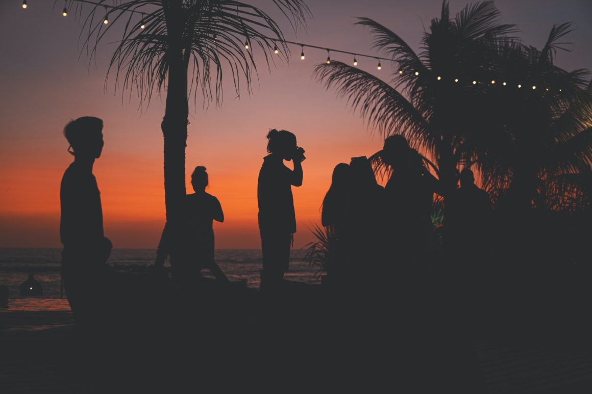 People having a party on an island during sunset