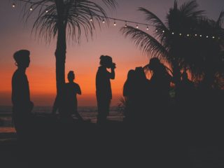 People having a party on an island during sunset