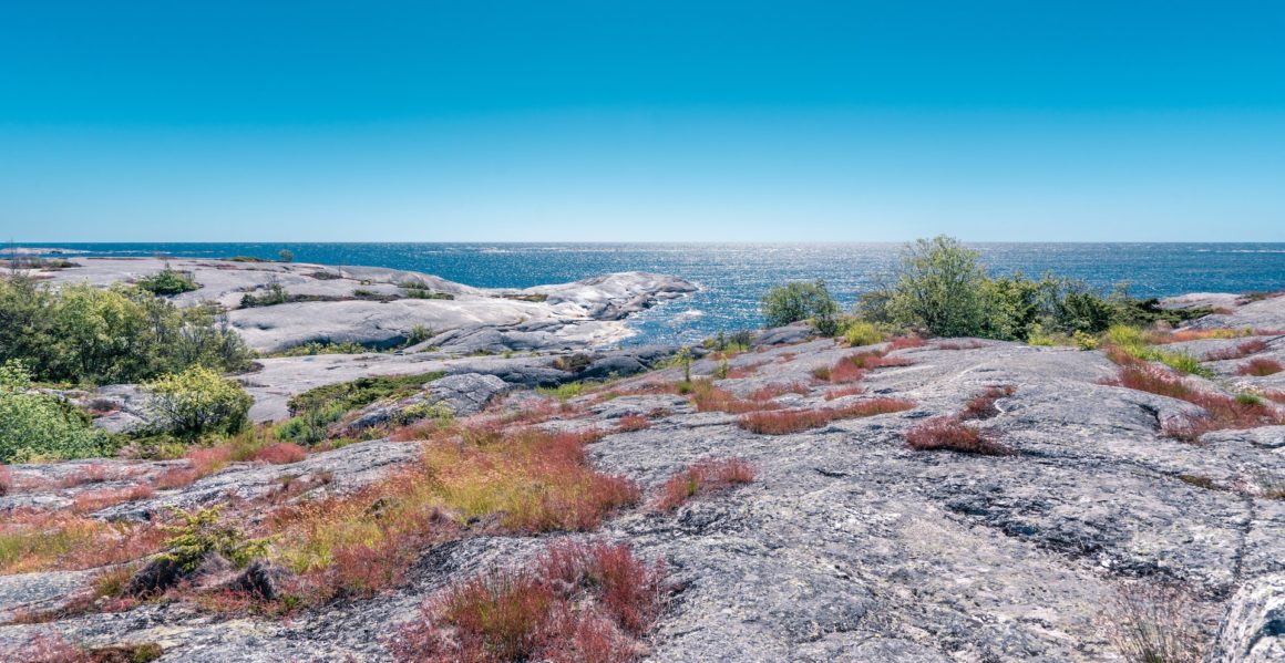 View of the blue sea with rocky beach in the foreground on the island of Huvudskär, home to one of the best European beaches.