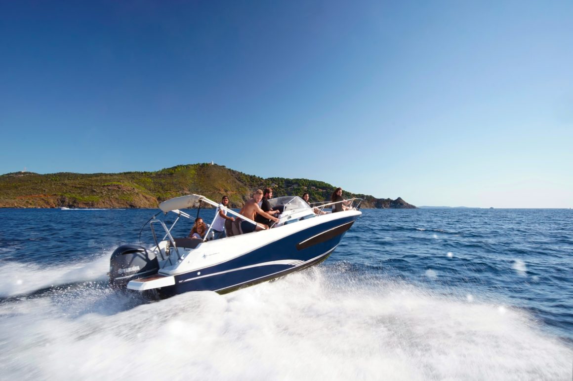 Motorboat, a type of boat propelled by an engine, cruising along the blue waters