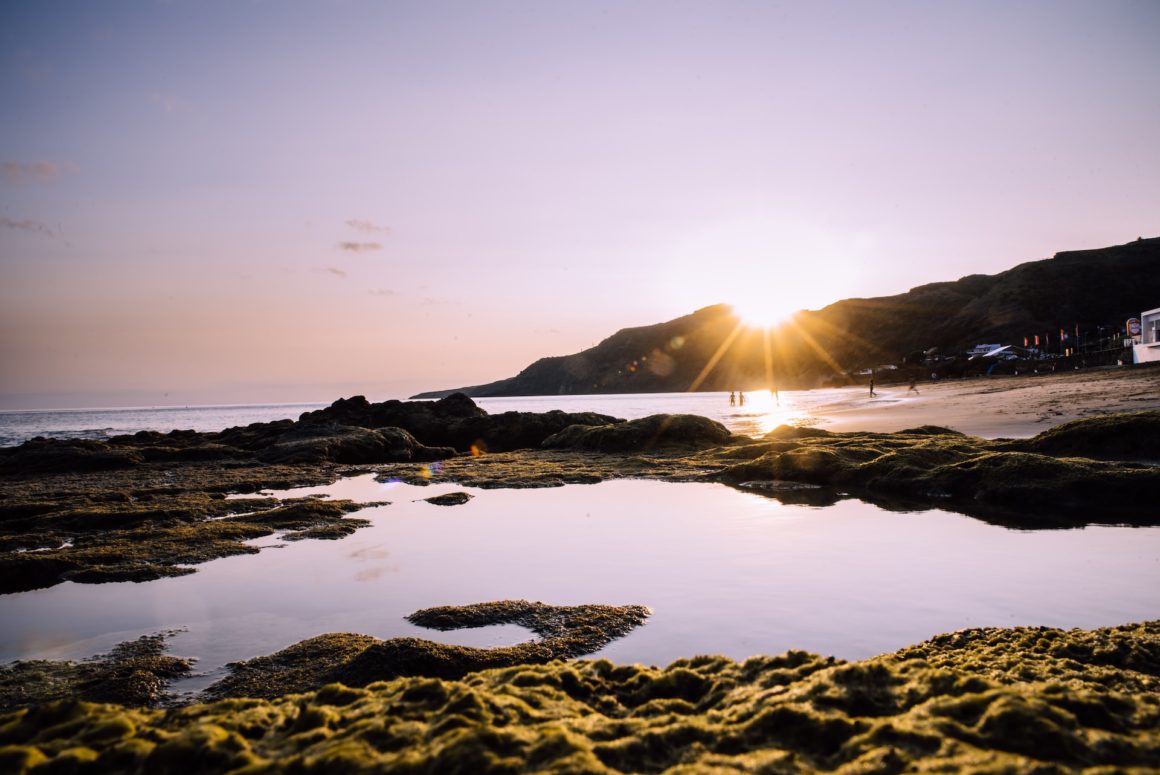 Sunset on one of the best European beaches. Beach in the Azores with rock pools and white sands.