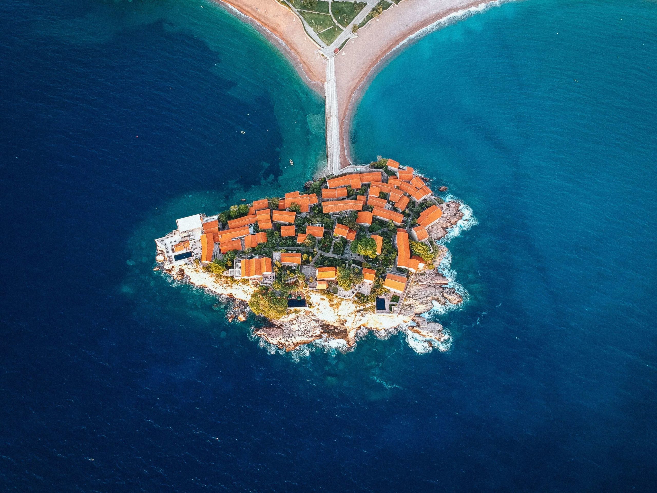 Aerial image os Sveti Stefan, a place to visit on a holiday in Montenegro