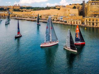 Regatta in Malta featuring colourful sailboats and Maltese architecture in the background