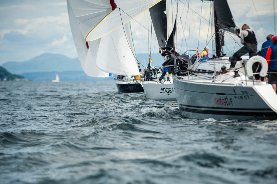 Sailboats navigating choppy water in a regatta