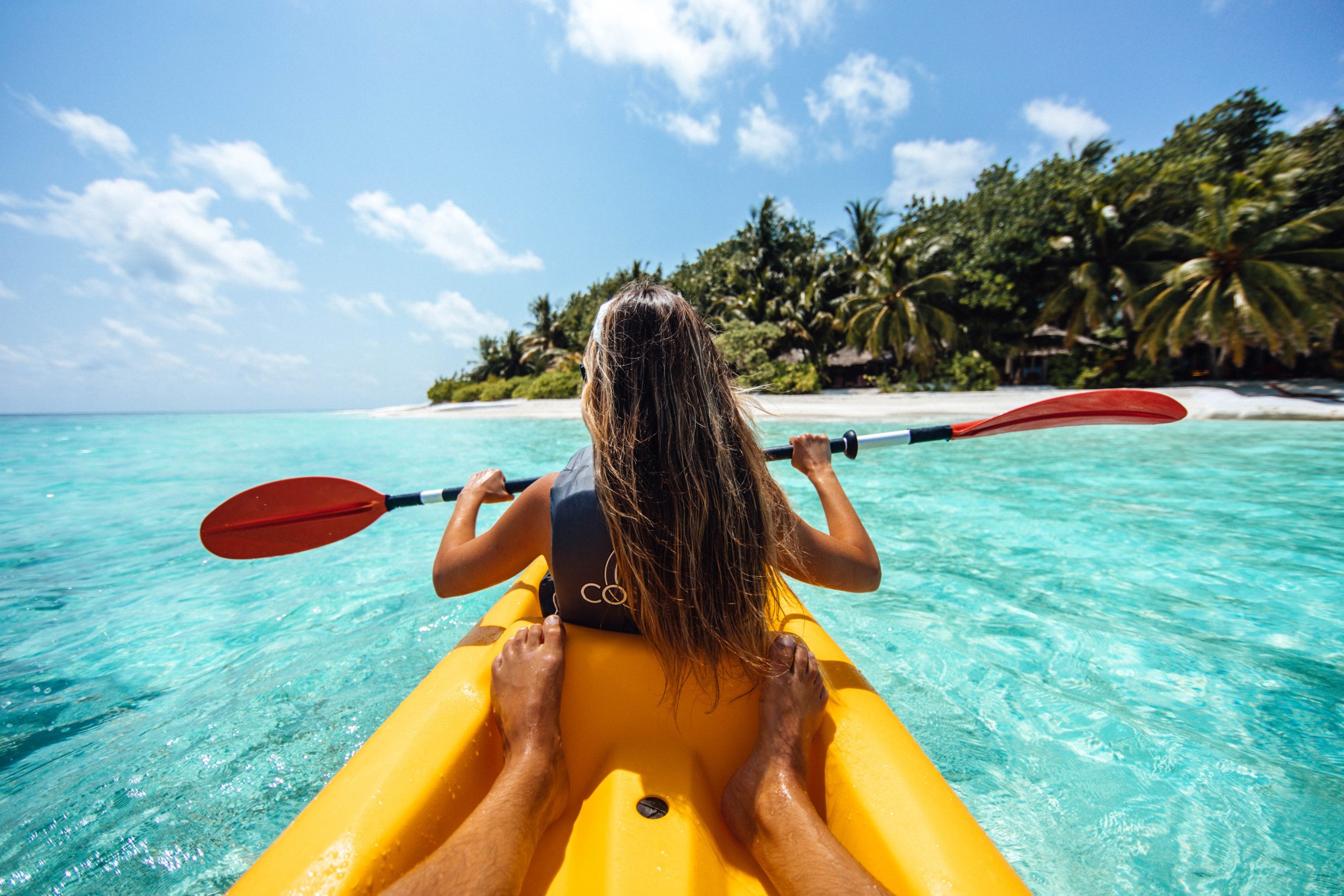Two people sea kayaking in a tropical location