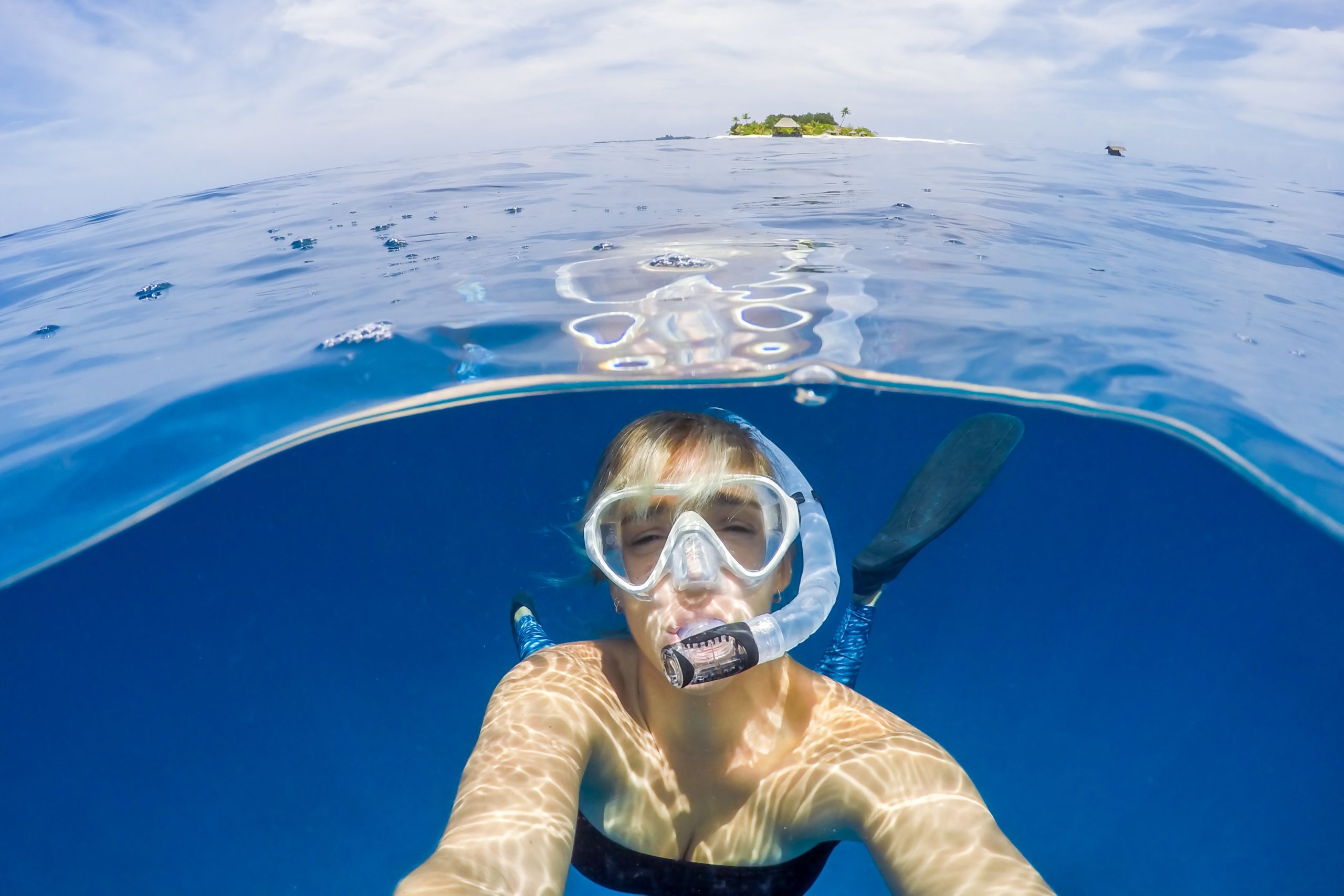 Woman taking selfie of herself snorkelling