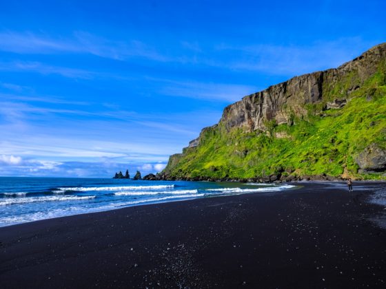 One of the best black sand beaches with lush greenery behind