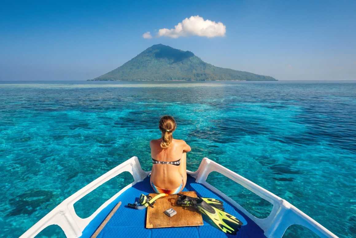 woman living on a boat surrounded by blue water