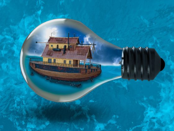 house boat in a light bulb surrounded by bright blue water