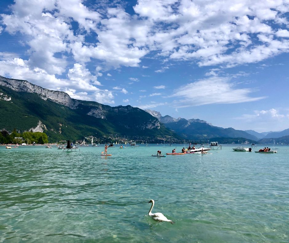 people paddleboarding and boating in Lake Annecy