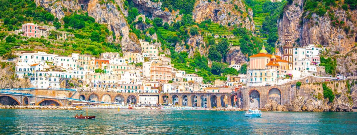Beautiful picture of an Italian city on a green and rocky cliff