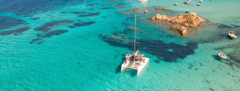 Catamaran mooring in the middle of the blue Mediterranean sea