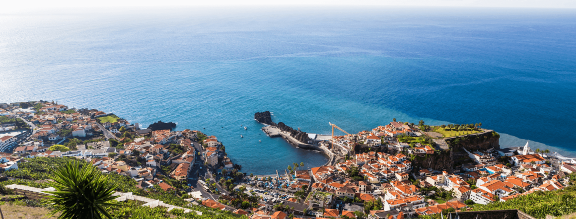 View from the coast of Madeira, overlooking a village and the sea.