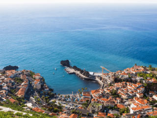 View from the coast of Madeira, overlooking a village and the sea.