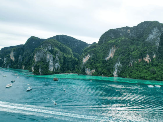 Aerial view of boats anchored in a turquoise bay in Thailand