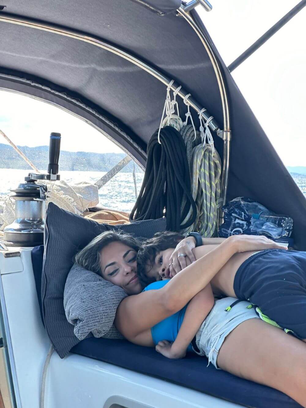 Andrew's wife, Hiba, and their 5-year-old-son, Arthur, cuddling on their sailboat