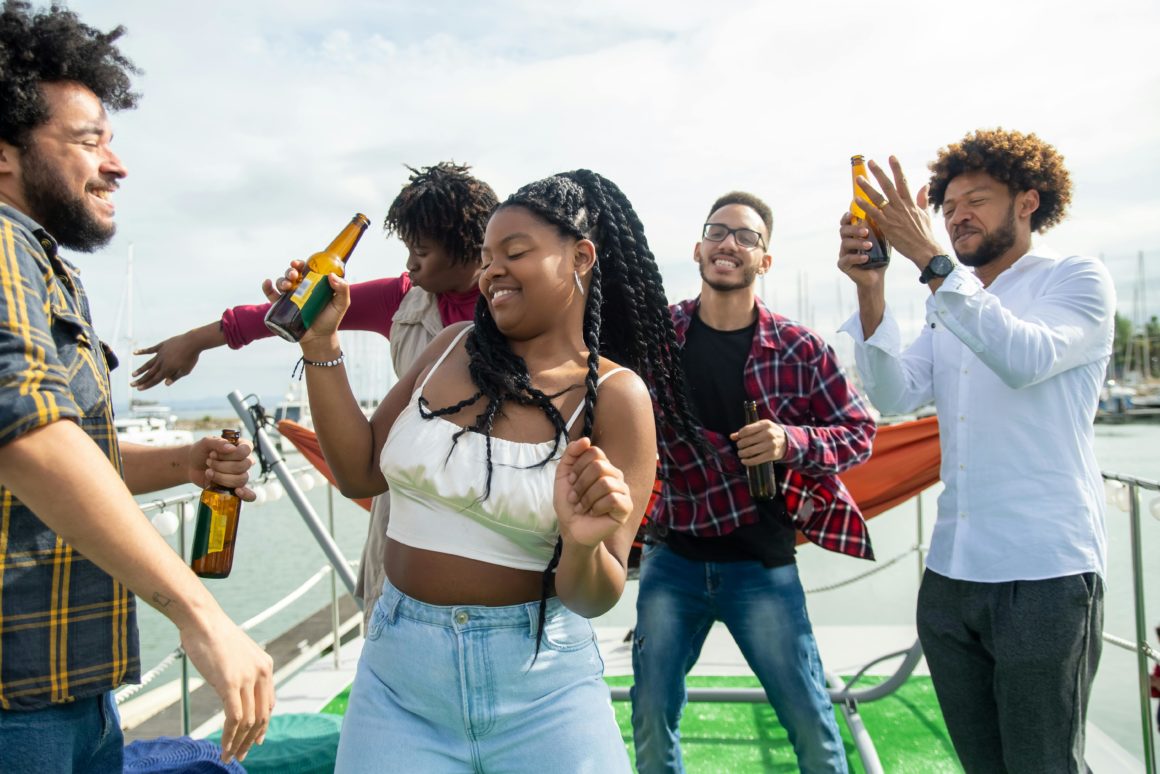 Friends enjoying a party and a drink on a boat
