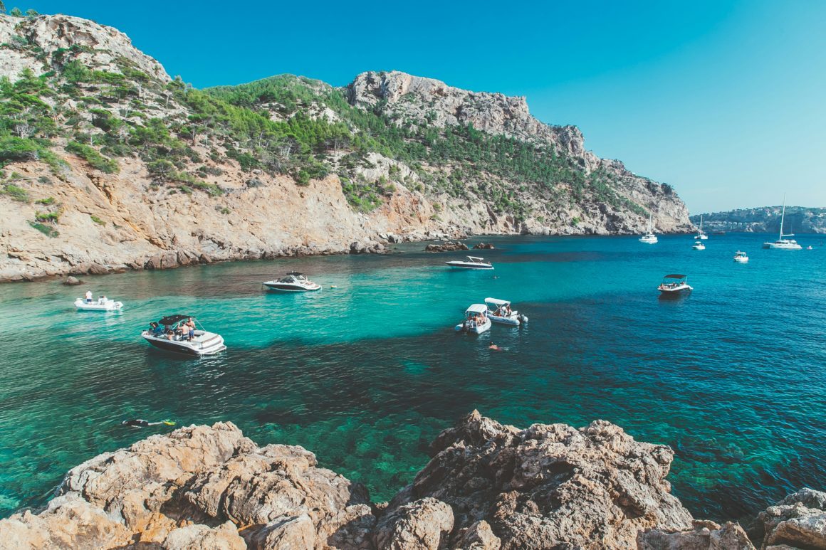 Boats in turquoise water in the Balearic Islands