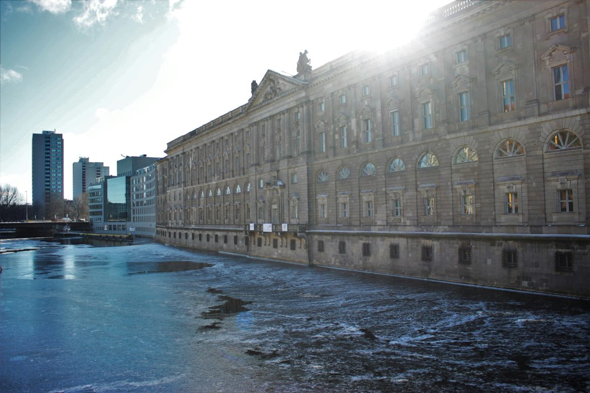 The River Spree flowing past the Berlin Palace on a sunny day.