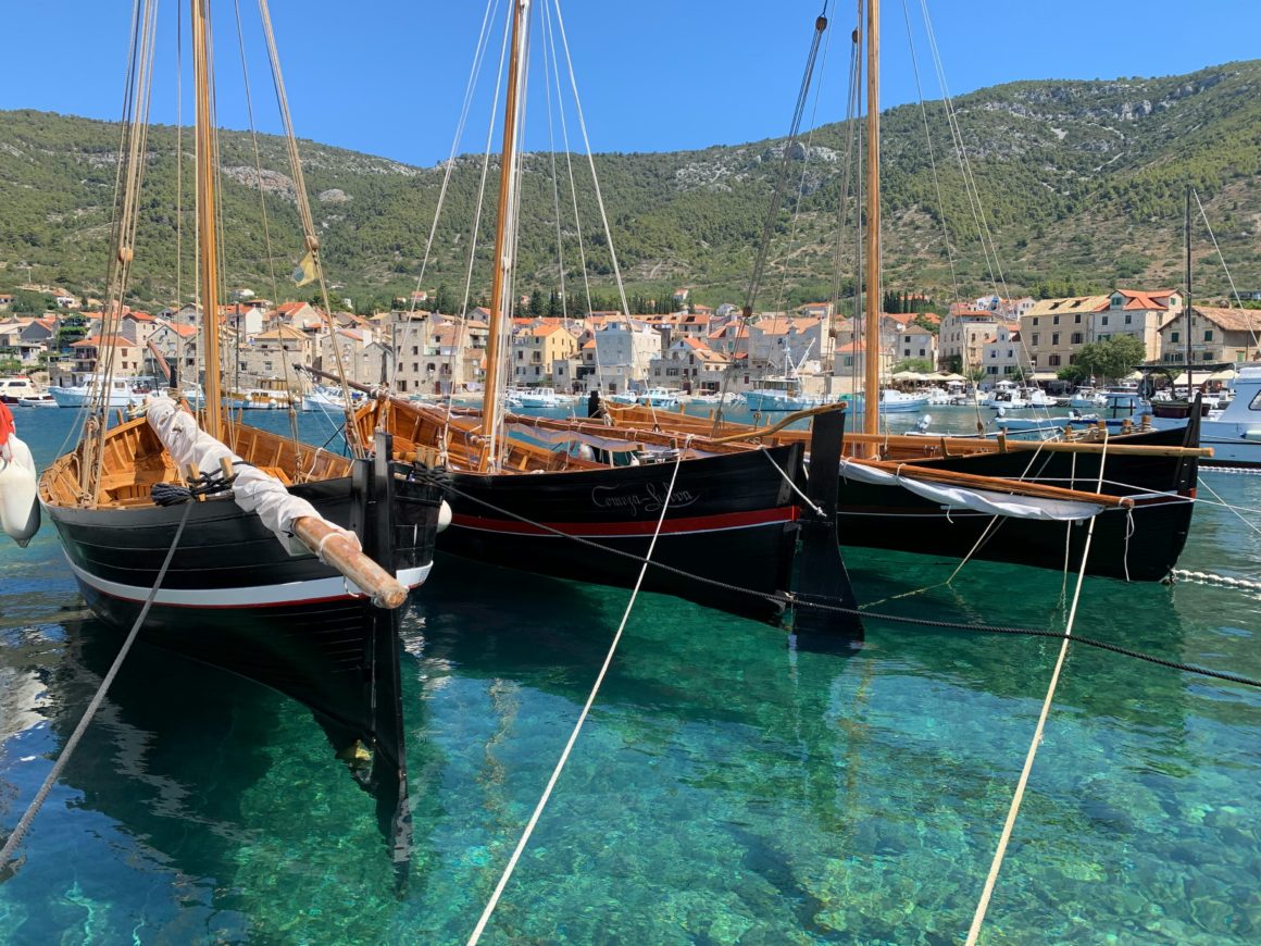 Traditional wooden fishing boats moored in Vis harbor.