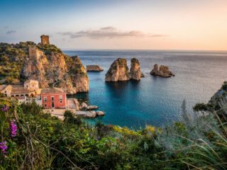 Historic tower and sea stacks of Scopello in Sicily.
