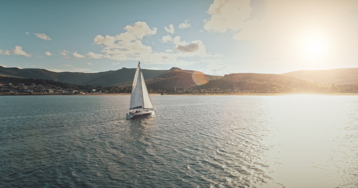 barca a noleggio che veleggia al tramonto