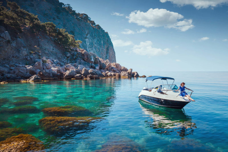 Day Cruiser on the Water, rocky cliff in the left background