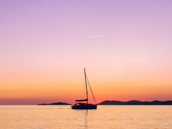 Catamaran cruising during sunset