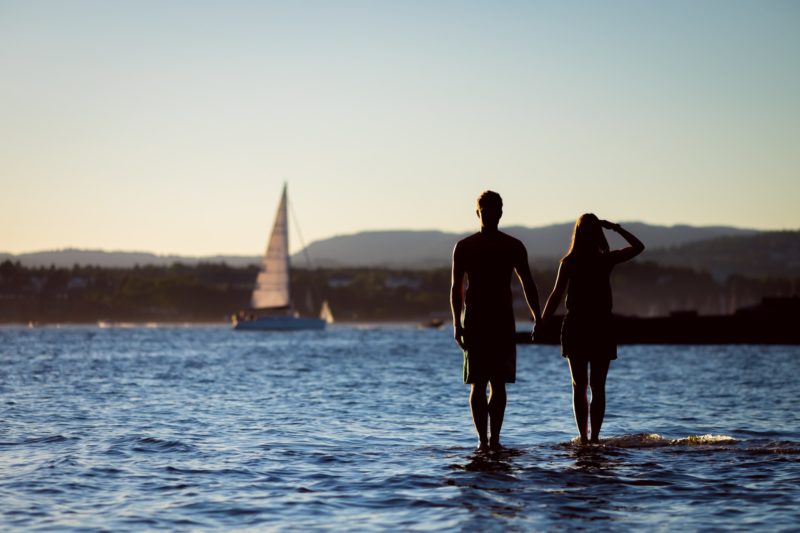 Sailing couple standing in the water