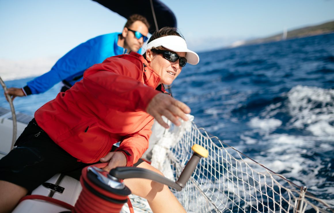 A sailor navigating a sailboat rental in the ocean