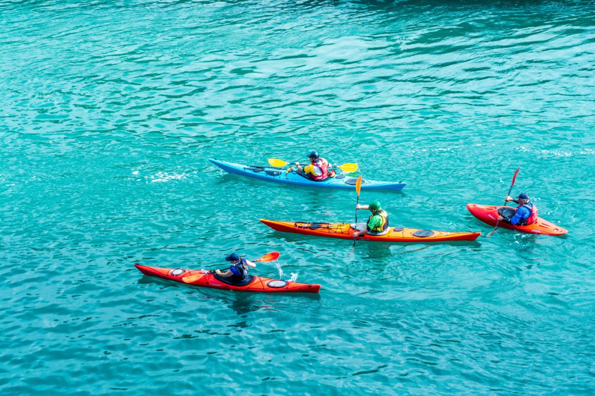 Group of people kayaking during their sailing vacation