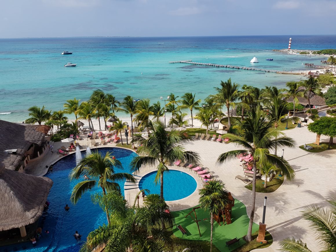 Beach with Palm trees in a sunny Cancun, Mexico