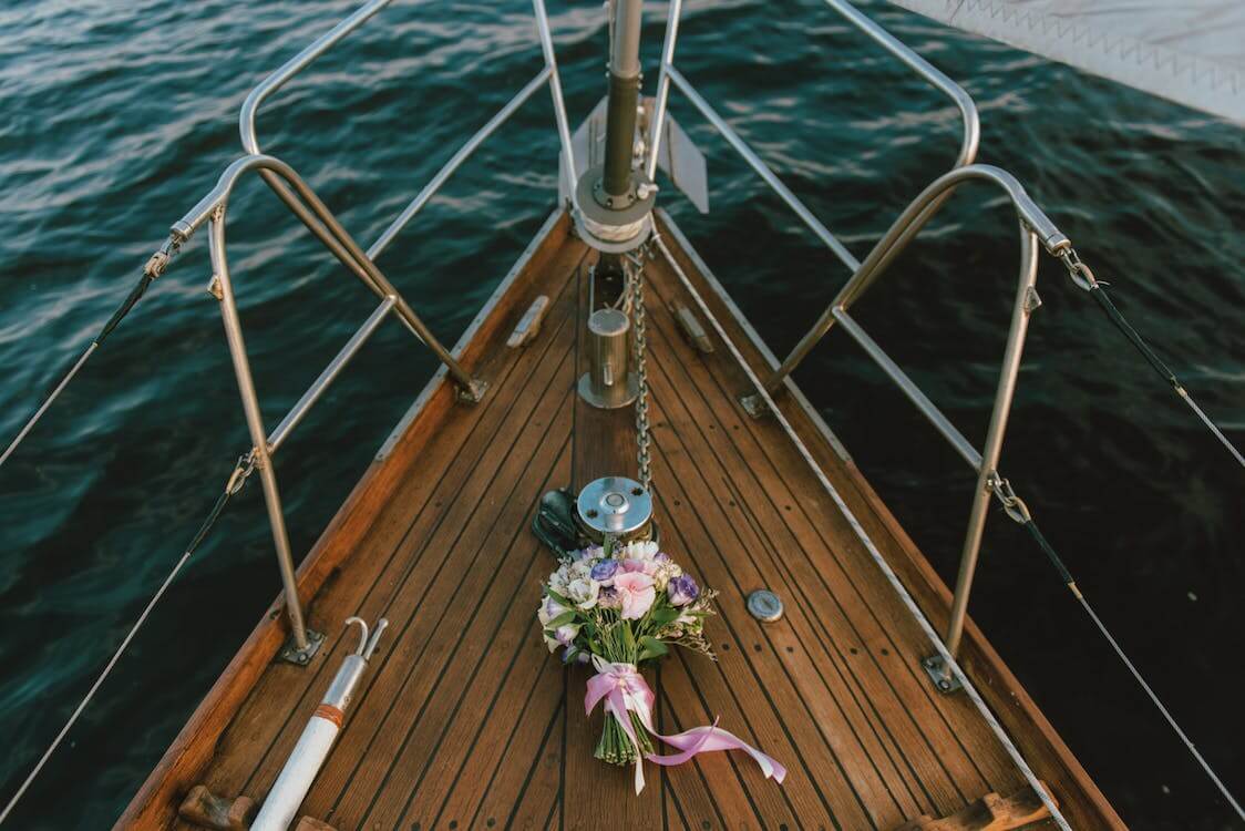 a flower bouquet on the bow of a boat