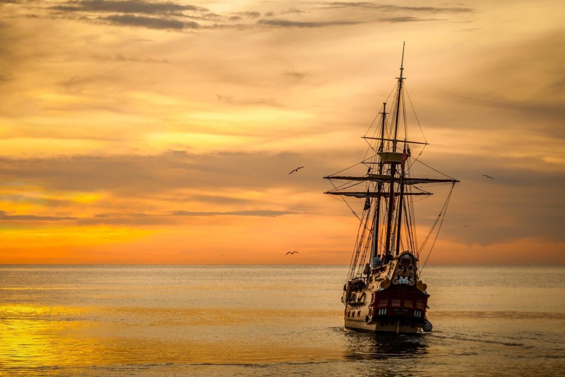 ship and a cloudy yellow sunset