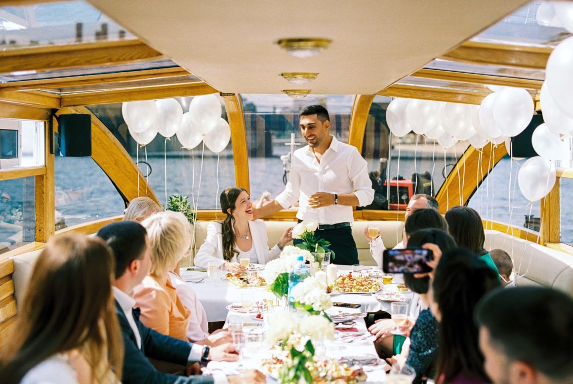 wedding party toasts on a boat